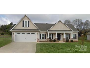 Charming single-story home featuring a covered front porch, manicured lawn, and an attached two-car garage at 275 Dorothy Dr, China Grove, NC 28023