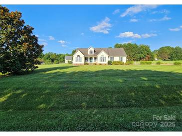 Charming one-story home with a well-manicured lawn and lush landscaping at 417 Garret Ln, York, SC 29745