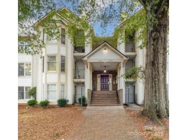 Inviting condo exterior features a covered entrance, stairs, and well-maintained landscaping at 6260 Rosecroft Dr, Charlotte, NC 28215