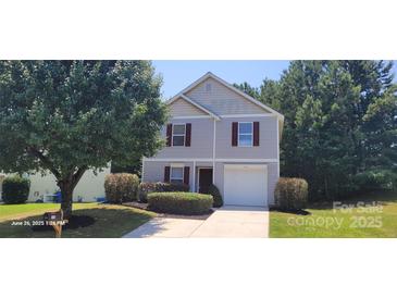 Charming two-story home featuring a single-car garage and manicured landscaping at 165 Brantley Place Dr, Mooresville, NC 28117