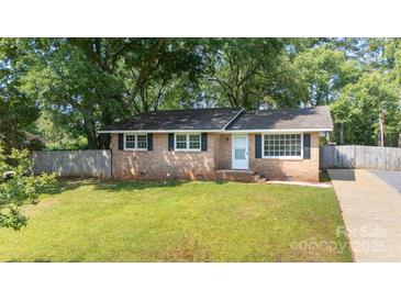 Charming brick home with a well-maintained front yard and mature trees at 1655 Woodhaven Rd, Rock Hill, SC 29732