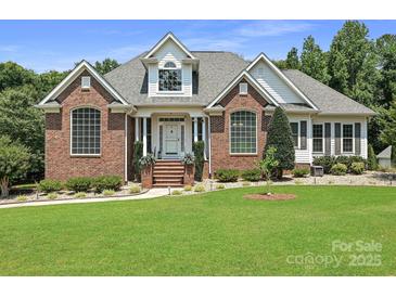 Charming brick home with manicured lawn and lovely landscaping at 1842 Caroline Way, Fort Mill, SC 29715