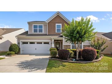 Two-story home featuring manicured landscaping, a two-car garage, and a mix of siding and stone accents on the facade at 4022 Perth Rd, Indian Land, SC 29707