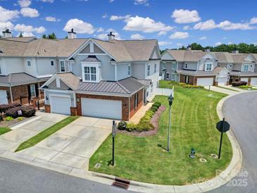 Charming townhome with manicured lawn, two-car garage, and inviting curb appeal at 44424 Oriole Dr # 200, Indian Land, SC 29707