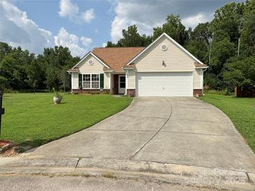 Charming single-story home with well-manicured lawn and inviting two-car garage at 1412 Cold Creek Pl, Huntersville, NC 28078