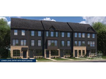 Modern townhome exterior featuring dark siding and a mix of brick and siding accents at 1474 Samuel St, Charlotte, NC 28206