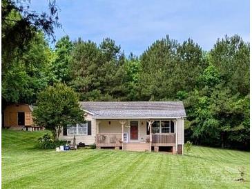 Charming single-story home with well-maintained lawn and inviting front porch at 201 N Ferry St, New London, NC 28127