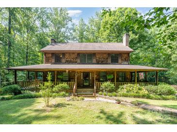Charming two-story home with a large, inviting front porch and mature landscaping at 2615 Highway 557 None, Clover, SC 29710
