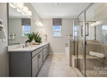 A spacious bathroom featuring a glass shower, double vanity, and modern fixtures at 3134 Beacon Heights Rd, Indian Land, SC 29707