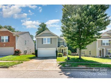 Charming two-story home with attached garage and well-manicured lawn in a suburban neighborhood at 1432 Matthew Allen Cir, Kannapolis, NC 28081