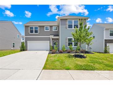 Charming two-story home featuring a well-manicured lawn, attached garage, and welcoming front entrance at 2512 Andes Dr, Statesville, NC 28625