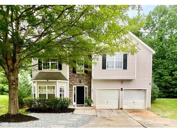 Charming two-story home featuring a two-car garage, stone accents, and a well-manicured lawn at 4205 Springhaven Dr, Charlotte, NC 28269
