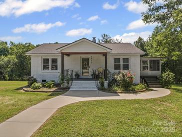 Charming single-story home featuring a well-manicured lawn and welcoming front porch at 4615 Lockhart Rd, Sharon, SC 29742