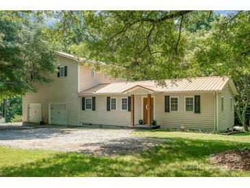 Charming two-story home with a metal roof, black shutters, and mature trees offering plenty of shade at 4919 Rehobeth Rd, Waxhaw, NC 28173