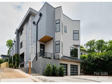 Striking modern home with a two-car garage and eye-catching architectural design at 1511 Waverly Ave, Charlotte, NC 28203