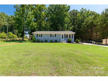Charming one-story home with light blue brick, black shutters, and a large lawn at 203 Nottingham Dr, York, SC 29745