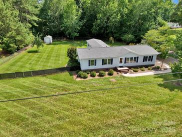 Charming single-story home with meticulously maintained landscaping and a fenced backyard at 329 W Red Cross Rd, Oakboro, NC 28129