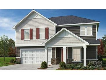 Charming two-story home features a classic design with a two-car garage and inviting front porch at 4457 Family Trail Dr, Indian Land, SC 29707