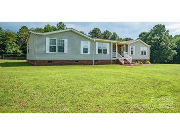 Charming single-story home featuring a welcoming front porch, gray siding, and a well-maintained lawn at 6785 Knotty Wood Ln, Vale, NC 28168