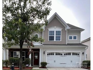 Charming two-story home featuring a two-car garage, landscaped front yard, and inviting entrance at 1307 Farm Branch Sw Dr, Concord, NC 28027