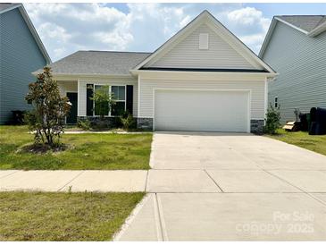 Charming single-Gathering home boasts a two-car garage, manicured lawn, and stylish exterior at 211 Surrey Oak Ln, Charlotte, NC 28216