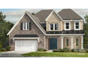 Charming two-story home featuring stone accents, a two-car garage, and a welcoming front entrance at 3073 Tramore Dr, Harrisburg, NC 28075