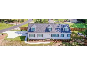 Charming home with well-manicured lawn, driveway, and inviting curb appeal at 7039 Executive Cir, Denver, NC 28037