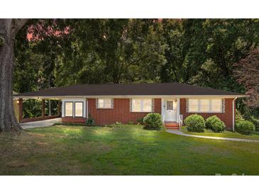 Charming one-story brick home featuring a well-maintained lawn and cozy covered parking at 207 W 21St St, Kannapolis, NC 28081