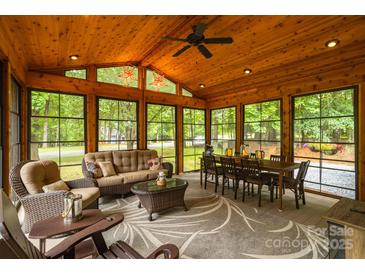 Inviting sunroom features a wood ceiling, large windows, and comfortable seating for relaxation and dining at 2156 Wedgewood Dr, Matthews, NC 28104