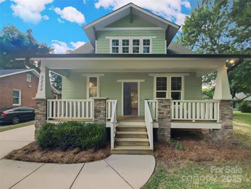 Charming two-story home with a welcoming front porch and stone accents at 2222 Camp Greene St, Charlotte, NC 28208