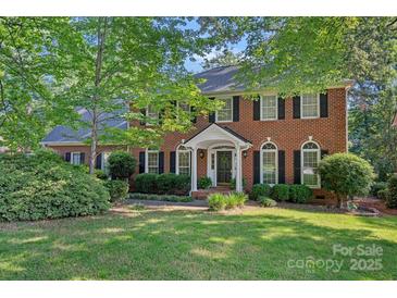 Beautiful two-story brick home with manicured lawn and mature trees at 2358 Sparrow Dr, Rock Hill, SC 29732