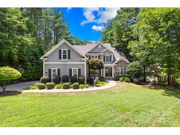Charming two-story home featuring a manicured lawn, lush landscaping, and a welcoming front porch at 2455 Talbot Ct, Sherrills Ford, NC 28673