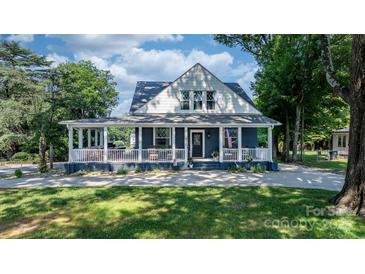 Charming two-story home with a welcoming front porch and beautifully landscaped yard at 704 N Main Ave, Newton, NC 28658