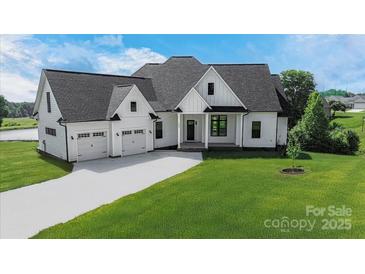 Charming modern farmhouse with a three-car garage, lush lawn and elegant black and white trim at 108 Augusta Ln, Shelby, NC 28150