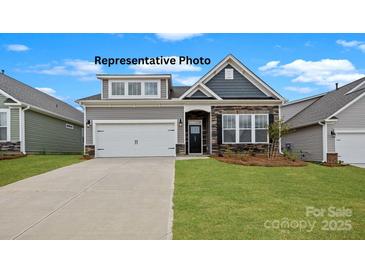 Charming single-Gathering home featuring stone accents and a well-manicured lawn at 152 Asmodean Ln, Troutman, NC 28166
