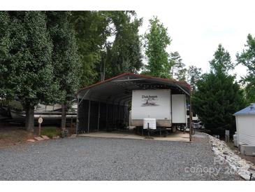The charming RV with cover offers convenient parking and protection from the elements at 155 Holly Harbor Trl, Mount Gilead, NC 27306