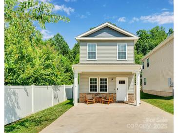 Charming two-story home with a welcoming front porch and manicured lawn at 2662 14Th Ne St, Hickory, NC 28601