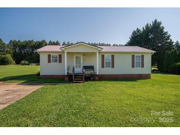 Charming single-story home with a well-maintained lawn and inviting front porch at 2694 Rock Dam Rd, Lincolnton, NC 28092
