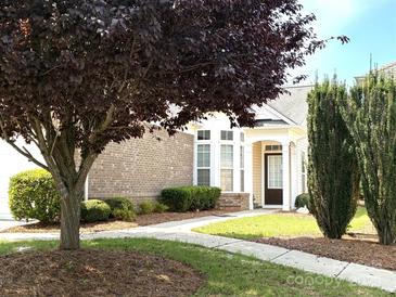 Charming home exterior with a well-manicured lawn, a welcoming entrance, and mature trees in the front yard at 7406 Carolina Jessamine Ct, Indian Land, SC 29707