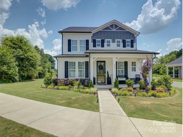 Charming two-story home with landscaped front yard and welcoming front porch at 9507 Pointer Rd, Huntersville, NC 28078
