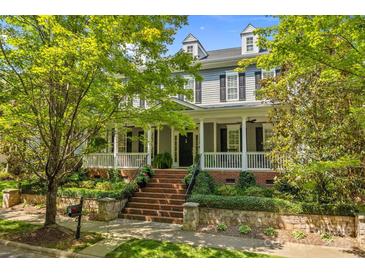 Charming two-story home featuring a welcoming front porch and beautifully landscaped front yard at 15628 Waterfront Dr, Huntersville, NC 28078