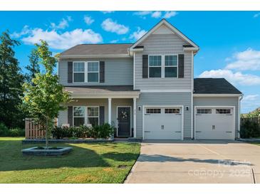 Charming two-story home featuring gray siding, a two-car garage, and a well-manicured lawn at 210 Clove Hitch Dr, Statesville, NC 28677