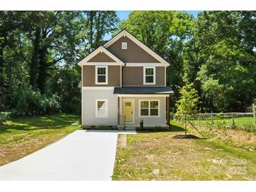 Charming two-story home with a modern exterior, neat lawn, and a newly poured concrete driveway at 2732 Mayfair Ave, Charlotte, NC 28208