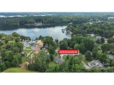 Stunning aerial view of lakefront property at 8275 Normandy Rd surrounded by lush greenery and waterfront access at 8275 Normandy Rd, Denver, NC 28037