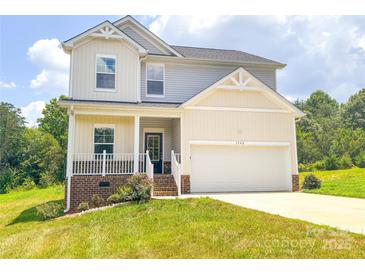Charming two-story home with a well-manicured lawn and attached two-car garage at 1542 Antioch Dr, Conover, NC 28613