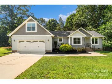 Charming single-Gathering home boasts a well-manicured lawn and an attached two-car garage at 1774 Timmons Marie Ln, Lincolnton, NC 28092