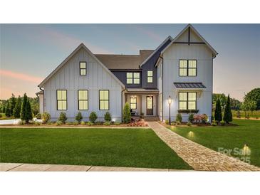 Charming two-story home featuring a manicured lawn, brick walkway, and craftsman-style details at 3308 Forest Lawn Dr, Weddington, NC 28104