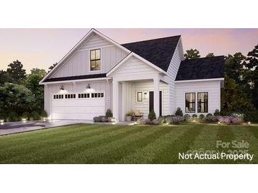 Charming new construction home with white siding, a manicured lawn, and an attached two-car garage at 7548 Baybrooke Ln # 26, Harrisburg, NC 28075