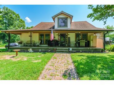 Charming home featuring a covered porch, brick pathway, and welcoming curb appeal at 106 Guffey Rd, Cherryville, NC 28021