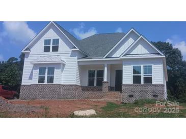 Beautiful new construction home with brick base, white siding, and covered front porch at 156 Triple Ponds Ct, Clover, SC 29710
